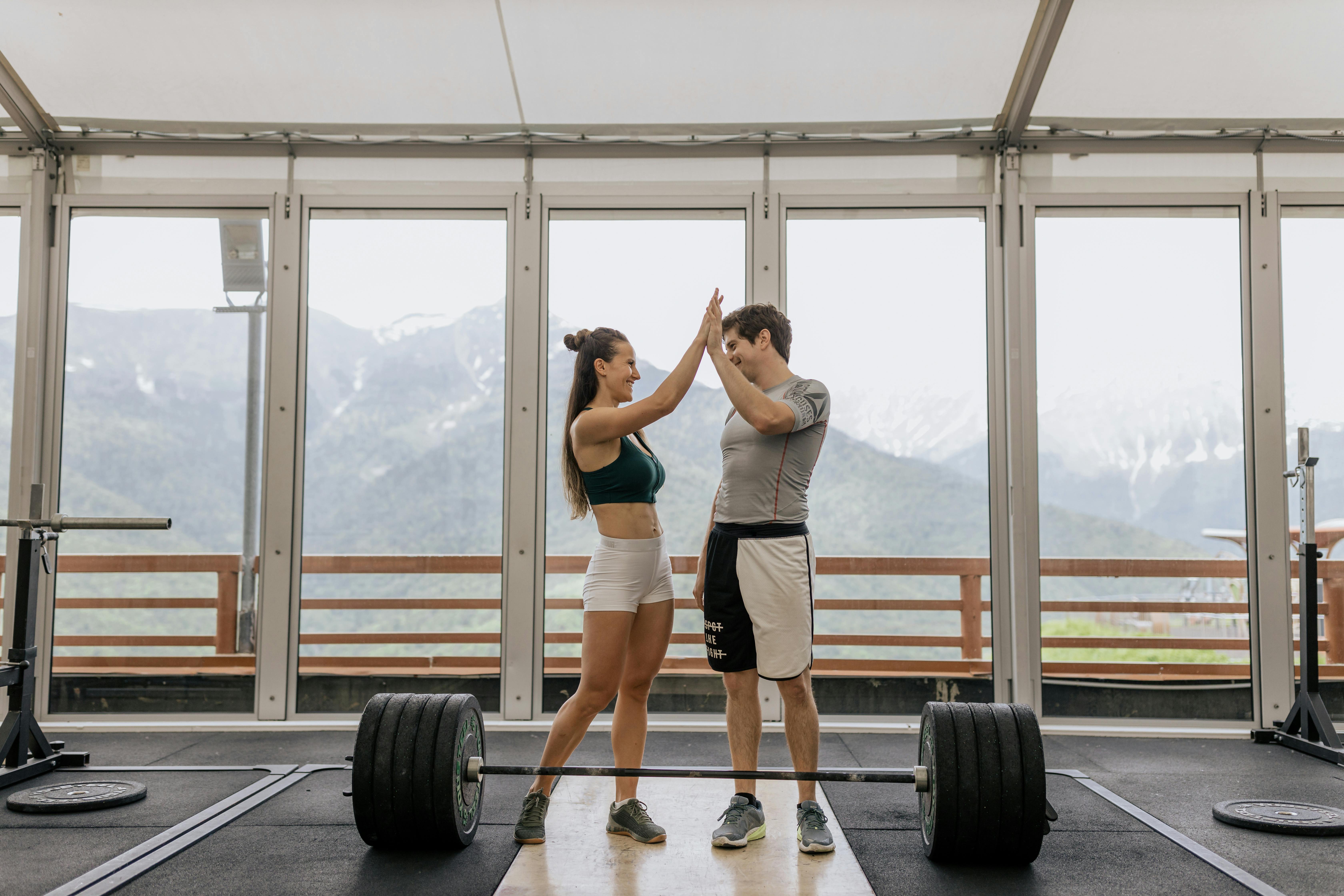 Two people high-fiving after a workout